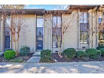 Charming townhome with well-maintained landscaping and mature trees adding curb appeal at 13 Ivy Ne Sq, Atlanta, GA 30342