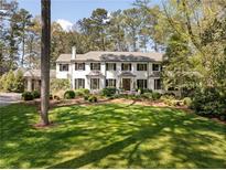 Stately home with a manicured lawn and mature landscaping; features a neutral color palette and classic design at 3540 Tuxedo Nw Rd, Atlanta, GA 30305