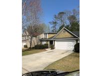 Charming home featuring a well-maintained lawn, complemented by a two-car garage and beautiful landscaping at 8236 Eastshore Dr, Union City, GA 30291