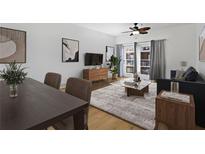 Inviting living room featuring a ceiling fan, neutral color palette and access to the balcony at 799 Hammond Dr # 205, Sandy Springs, GA 30328
