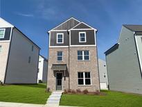 New two-story brick home featuring a modern design with gray accents and a well-manicured front lawn at 1352 Creekside Nw Cir, Atlanta, GA 30318