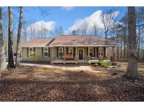 Charming single-story home featuring a cozy front porch and a well-maintained yard at 138 Rutledge Rd, Temple, GA 30179