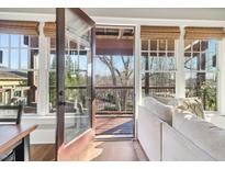 Inviting living room with an open door to a balcony and large windows with woven shades at 5910 Bond St # 401, Cumming, GA 30040
