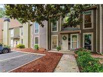 Inviting townhome with beautiful landscaping, private entrance, and dedicated parking space at 1088 Riverbend Club Se Dr, Atlanta, GA 30339