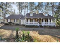 Charming single-Gathering home featuring a welcoming front porch and lush landscaping at 3281 Old Salem Rd, Conyers, GA 30013