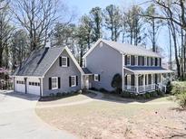 Charming two-story home with gray siding, black shutters, and a welcoming front porch at 3784 Overlook Nw Trl, Kennesaw, GA 30144