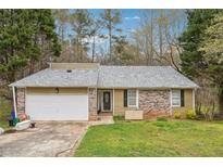 Charming one-story home featuring a brick facade and a spacious two-car garage at 845 James Path Ct, Lawrenceville, GA 30044