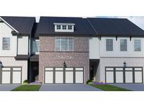 Charming brick and siding townhome with a two-car garage and a well-manicured lawn at 293 Depot Landing Rd, Auburn, GA 30011
