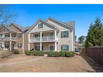 Charming two-story home with a welcoming front porch and well-manicured landscaping at 307 Montgomery Way, Woodstock, GA 30188