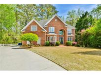 Traditional brick home with well-manicured lawn and mature landscaping, offering great curb appeal at 3816 Berrybridge Se Way, Marietta, GA 30067
