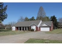 Charming one-story brick home with attached garage, front yard, and a cozy front porch entrance at 2850 S Waterworks Rd, Buford, GA 30518