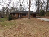 Charming single-story brick home featuring an open carport and front yard at 4269 Mercer Rd, Decatur, GA 30035