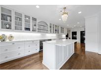 A gourmet kitchen with sleek countertops, stainless steel appliances, and a beautiful chandelier at 3286 Northside Nw Pkwy # 1007, Atlanta, GA 30327