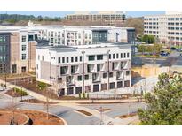 New townhome with attached garages, neutral colors and updated exterior design at 7110 Summit Pl, Alpharetta, GA 30009
