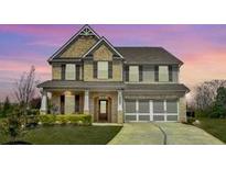 Inviting two-story home featuring brick and siding, attached garage and a manicured lawn at 526 Rosemont Ave, Canton, GA 30115