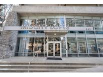 Modern building exterior of Midcity Lofts with large windows and stone accents, creating an inviting entrance at 845 Spring St # 125, Atlanta, GA 30308