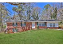 Charming single-story brick home with green shutters and a well-manicured front lawn at 272 Colchester Dr, Stone Mountain, GA 30088