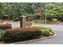 Well-maintained Dunwoody Court entrance with stone signage and manicured landscaping at 919 Dunbar Dr, Dunwoody, GA 30338