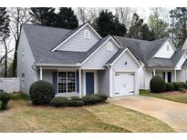 Charming home featuring vinyl siding, a one-car garage, and a well-manicured lawn at 253 Woodland Way, Canton, GA 30114