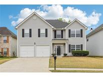 Charming two-story home featuring a two-car garage and well-maintained lawn with manicured bushes at 2529 Brookgate Way, Ellenwood, GA 30294
