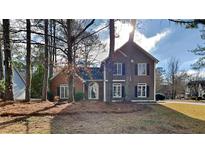 Charming two-story home featuring a combination brick and siding exterior and well-maintained landscaping at 3245 Country Walk Dr, Powder Springs, GA 30127