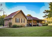 Charming exterior view of the home with a well-maintained lawn and inviting front porch at 3526 Highway 11 S, Mansfield, GA 30055