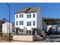 Charming new construction townhome featuring white siding and brick foundation in a desirable neighborhood at 333 Skylar Se Way, Atlanta, GA 30315