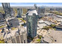Stunning aerial view showcases the high-rise condominium building with city skyline in the background at 3338 Peachtree Rd # Apt 403, Atlanta, GA 30326