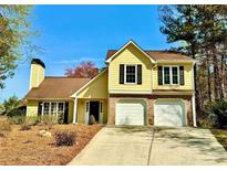 Charming two-story home with a two-car garage and a well-manicured front yard at 4722 Bradford Ln, Powder Springs, GA 30127