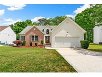Charming single-Gathering home with brick and siding exterior, manicured lawn, and attached garage at 1395 Brisbane Dr, Dacula, GA 30019