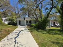 Charming single-story home with a well-maintained lawn and a long driveway at 2468 Baxter Sw Rd, Atlanta, GA 30315