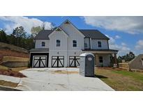 Stunning two-story home with white siding and a three-car garage, offering modern farmhouse charm at 138 Silvercrest Dr, Acworth, GA 30101