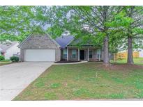Charming single-story brick home with well-maintained lawn and attached garage at 223 Gilliam Ct, Locust Grove, GA 30248