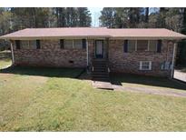 Traditional brick home with a well-manicured lawn, a inviting entrance with steps, and plenty of natural light at 5159 Covington Hwy, Decatur, GA 30035
