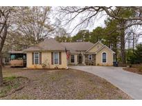 Charming one-story home with a mix of neutral siding, stone accents, and a well-manicured lawn at 10 Flowers Dr, Covington, GA 30014