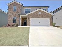 Beautiful two-story home featuring brick and neutral siding, manicured lawn, and attached two car garage at 516 Cunninghame Ct, Peachtree City, GA 30269