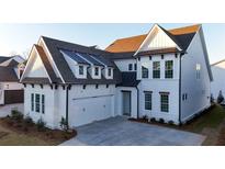Beautiful two-story home with a two-car garage, large windows, white siding, and a well-maintained front yard at 486 Broom Dr, Cumming, GA 30040