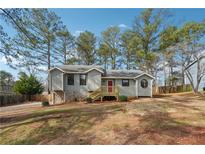 Charming gray home featuring a well-maintained lawn and a welcoming red front door at 3640 Barbara Dr, Douglasville, GA 30135