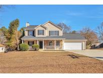 Charming two-story home featuring a welcoming front porch and a well-maintained lawn at 4785 Beaver Rd, Loganville, GA 30052