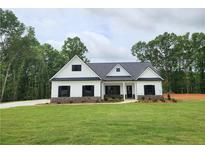 Charming single-story home with white siding, black shutters, and a lush green lawn at 490 Benson Meadows Dr, Dallas, GA 30157