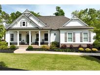 Charming craftsman-style home with a welcoming front porch and beautifully landscaped front yard at 305 Red Gate Ln, Canton, GA 30115