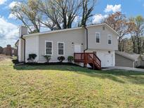 Charming two-story home with gray siding, a red deck, and a well-maintained lawn, perfect for curb appeal at 3690 Darrah Sw Way, Atlanta, GA 30331