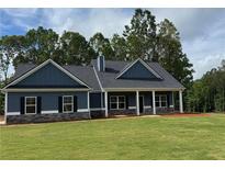 Charming single-story home with a welcoming front porch and a lush green lawn at 476 Benson Meadows Dr, Dallas, GA 30157