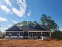 Charming new construction home with a covered front porch and craftsman-style details at 476 Benson Meadows Dr, Dallas, GA 30157