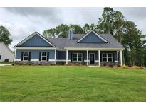 Charming single-story home with blue siding, a welcoming front porch, and a well-manicured lawn at 476 Benson Meadows Dr, Dallas, GA 30157