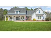 Charming two-story home featuring a landscaped front yard and inviting covered porch at 20 Tuscany Dr, Mansfield, GA 30055
