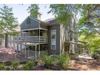 Inviting condo with outdoor living space, lush landscaping, and wood accents at 606 Se Riverview Dr # 606, Marietta, GA 30067
