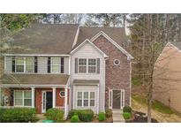 Charming townhome featuring stone and siding exterior with well-maintained landscaping and a welcoming entrance at 201 Creel Way, Atlanta, GA 30349