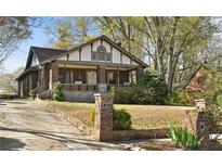 Charming two-story home with brick and stone accents, front porch, and a well-manicured lawn at 1716 Rogers Sw Ave, Atlanta, GA 30310