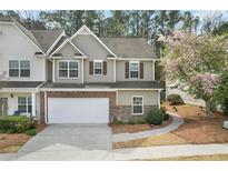 Charming two-story townhome featuring a brick facade, attached garage, and manicured landscaping, perfect for comfortable living at 331 Franklin Ln, Acworth, GA 30102